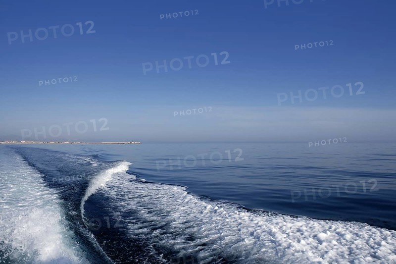 Blue sea ocean with boat wake, prop wash foam
