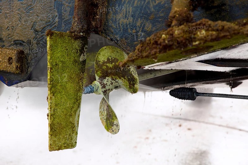 Boat stern hull and propeller pressure water cleaning on beached ship