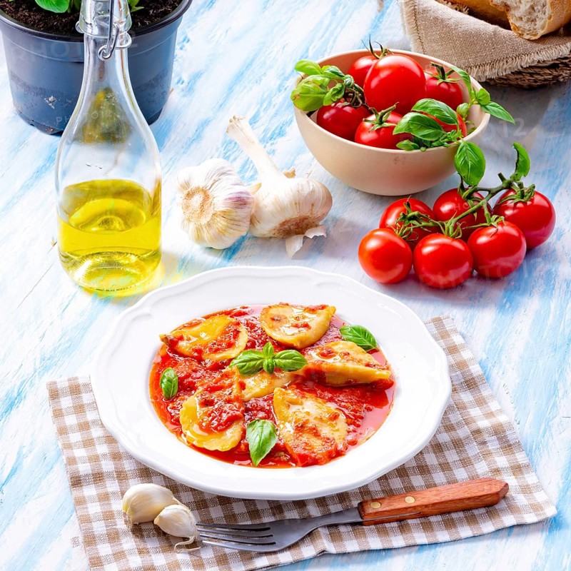 Delicious pasta - ravioli in tomato sauce with basil