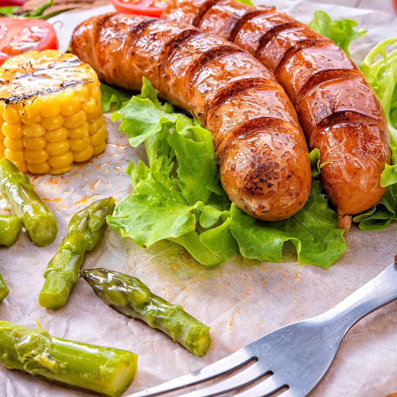 Grilled krakauer sausage with boiled corn and green salad