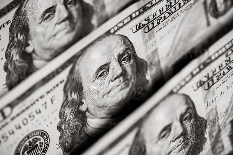Hundred dollars bills standing in a row. Selective focus