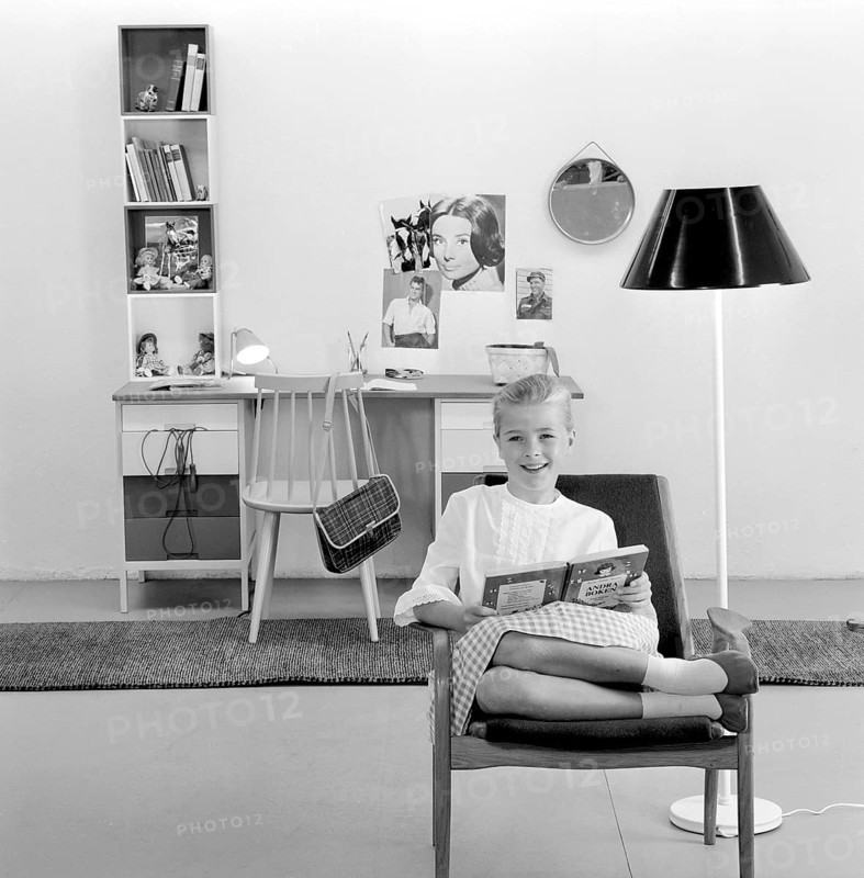 In the 1960s. A teenage girl in her typical 1960s room, a desk and her things with pictures of her idols of the wall Audrey Hepburn and Elvis Presley. Sweden 1960