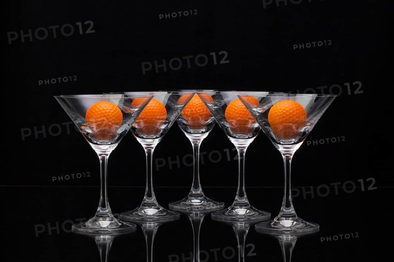 Five glasses of champagne with golf balls