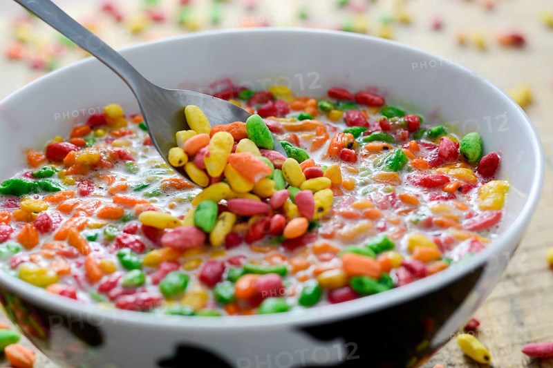 Prepared breakfast with colorful puffed rice with spilled rice in the background