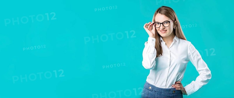 Blank for advertising. portrait young caucasian woman worker teacher coach mentor in white shirt office style business lady leader advertising glasses eyesight blue isolated colour background