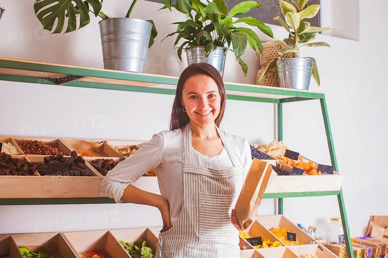 Portrait of woman seller in the grocery shop. Zero waste and raw food concept