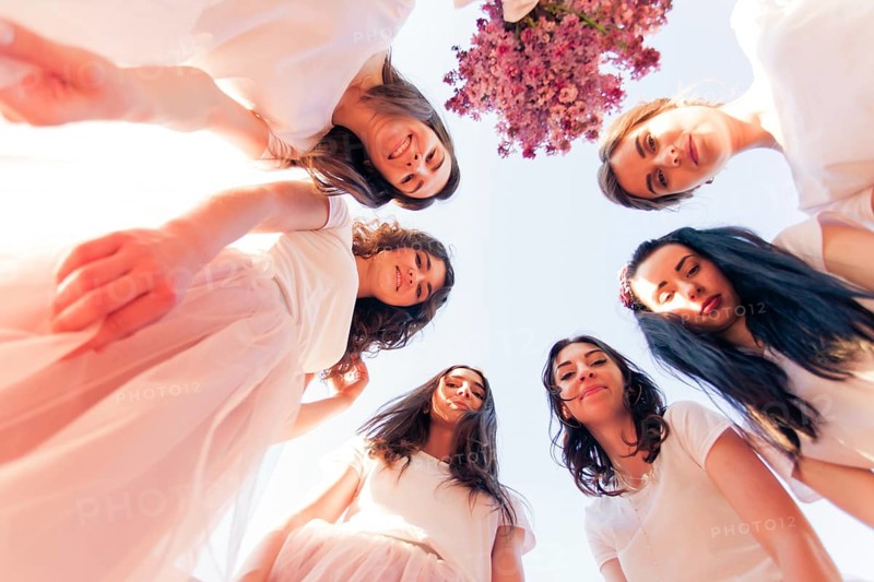 Happy young bridesmaids looking down together. Happy Hen party