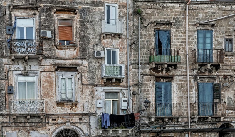 Taranto, Italy, 30 November, 2023: shabby chic derelict buildings with laundry hanging from the balconies in the Old Town of Taranto, Europe