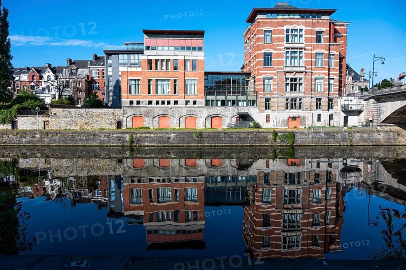 Namur, Wallon Region, Belgium, 07 28 2022, Historical buildings reflecting in the blue water of the River Sambre, Europe