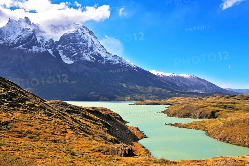 Asure Lake Pehoe water at the foot of the magnificent snow-covered cliffs of Los Kuernos. National Park Torres del Paine, Chile, South America