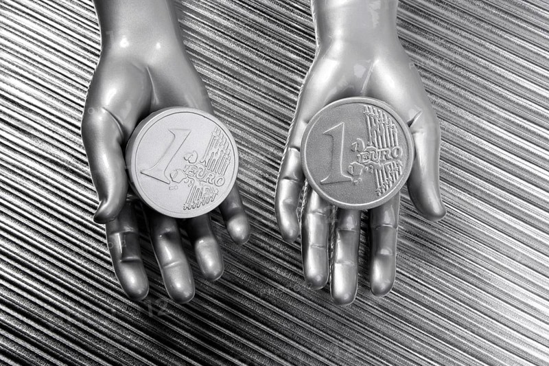 Two silver euro coins in futuristic robot gray metallic hands bank metaphor