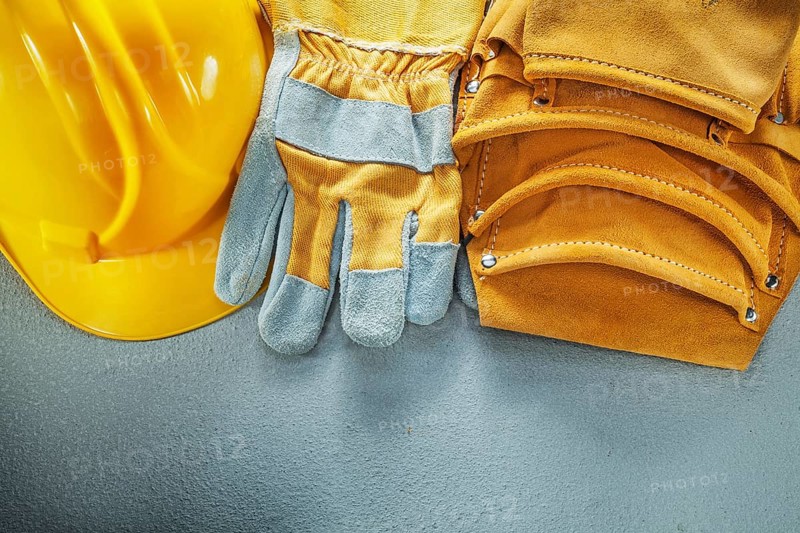 Tool belt protective gloves cap on concrete background