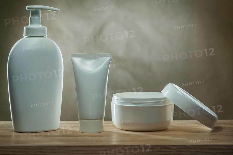 Body hygiene products two pump dispensers mockup blank white plastic bottles and facial cream in opened jar on wooden table