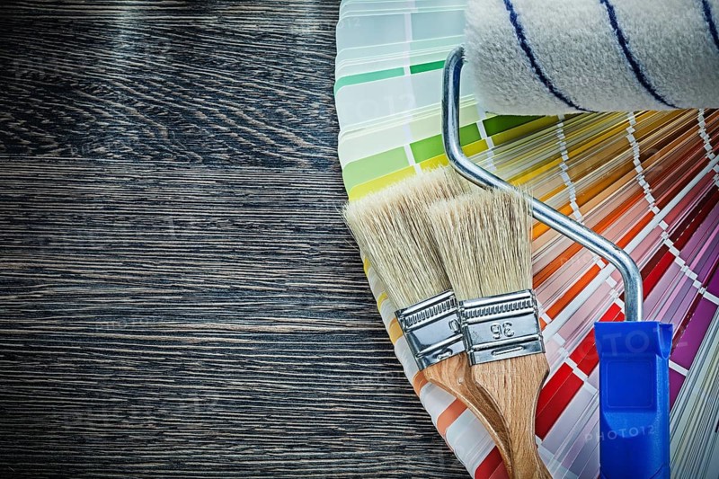 Paint brushes roller color pantone fan on wooden board