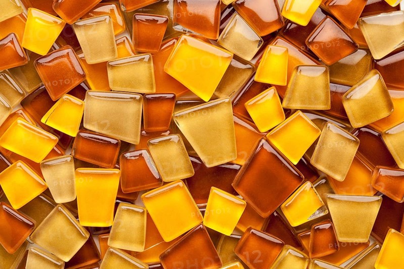 Random background of yellow, brown and amber glass mosaic tiles