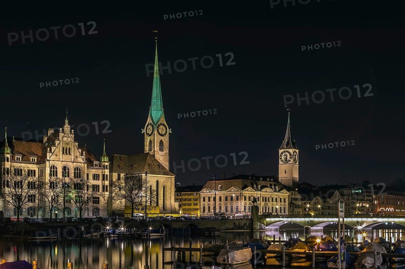 View of Limmat river with Fraumunster and st. Peter church in evening, Zurich