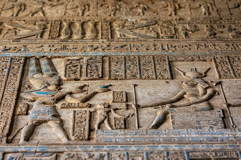 Hieroglyphic carvings on the exterior walls of an ancient egyptian temple