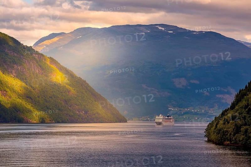 Norway colorful sunset Nordfjord fjord panorama with mountains landscape and cruise ship