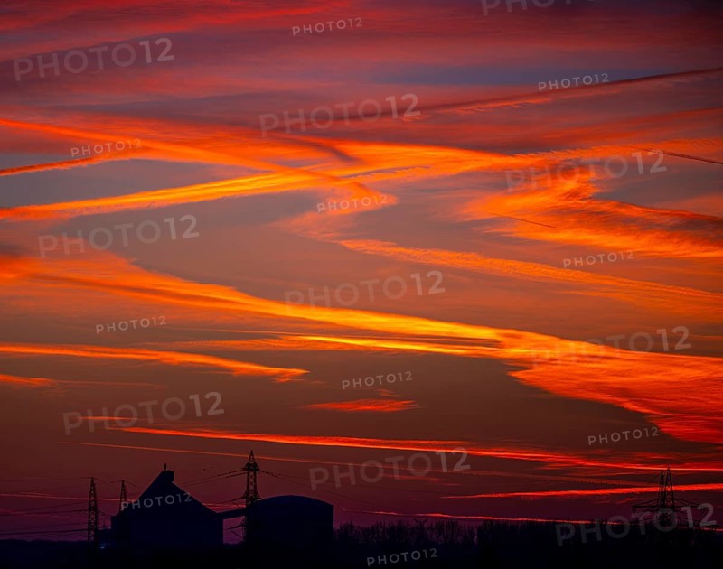 Sunset with red-coloured sky and contrails, Braunschweig, Lower Saxony, Germany, Europe