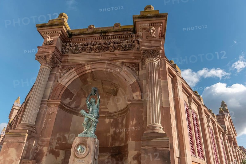 The statue of the winegrower, work of Auguste Bartholdi in front of the covered market in the city of Colmar. Alsace, France, Europe