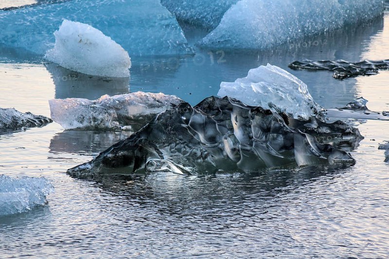 Ice pure like glass swimming in the Jokulsarlon glacial lake, Iceland, Europe