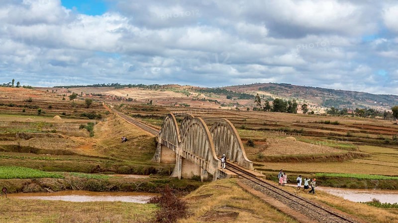 Malagasy people from the countryside cross a railroad bridge on the way to work and school on May 25, 2014 in Madagascar, Madagascar, Africa