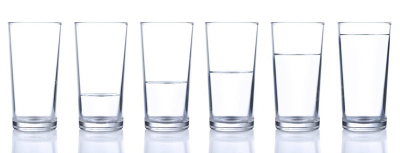 Six glasses with cold still water isolated on white background