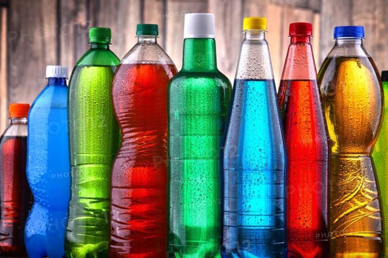 Plastic bottles of assorted carbonated soft drinks in variety of colors
