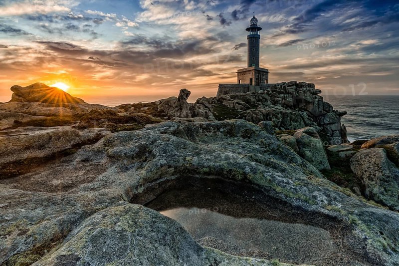 A beautiful sunset at the Punta Nariga lighthouse in Galicia
