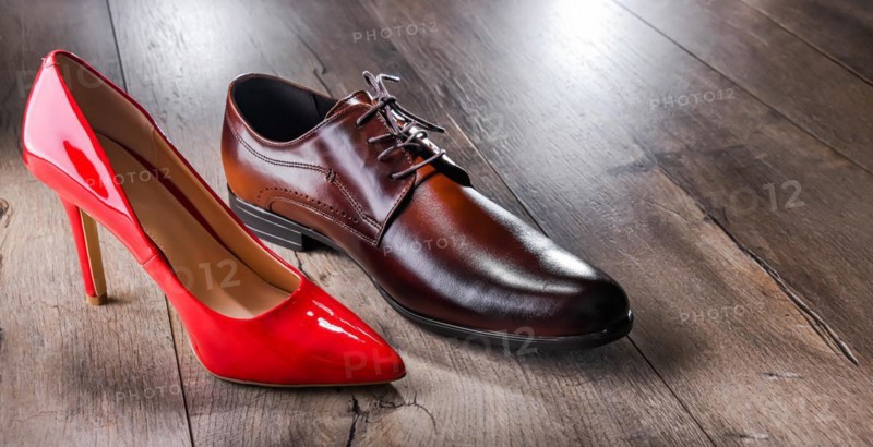Composition with a high heel women's shoe and a men's shoe