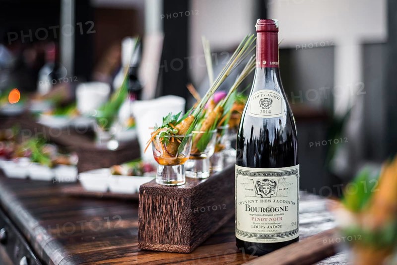 Bottle of red bourgogne wine at oudoor party bar counter