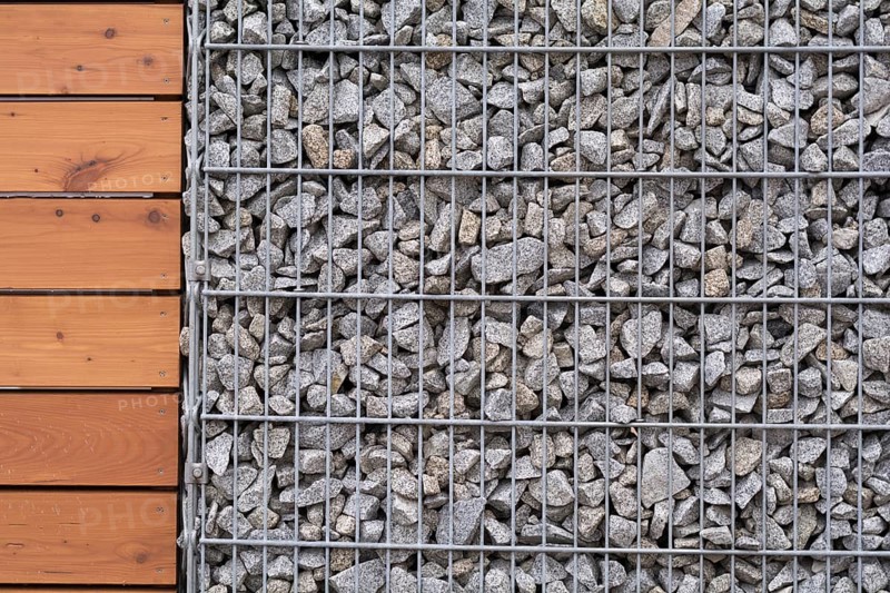 Close-up of stone-wood fence - text free space