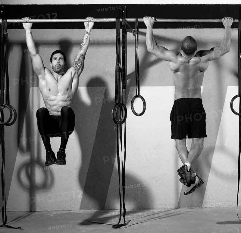 Crossfit toes to bar men pull-ups 2 bars workout exercise at gym