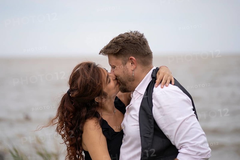 Lovers hug and kiss on a beach