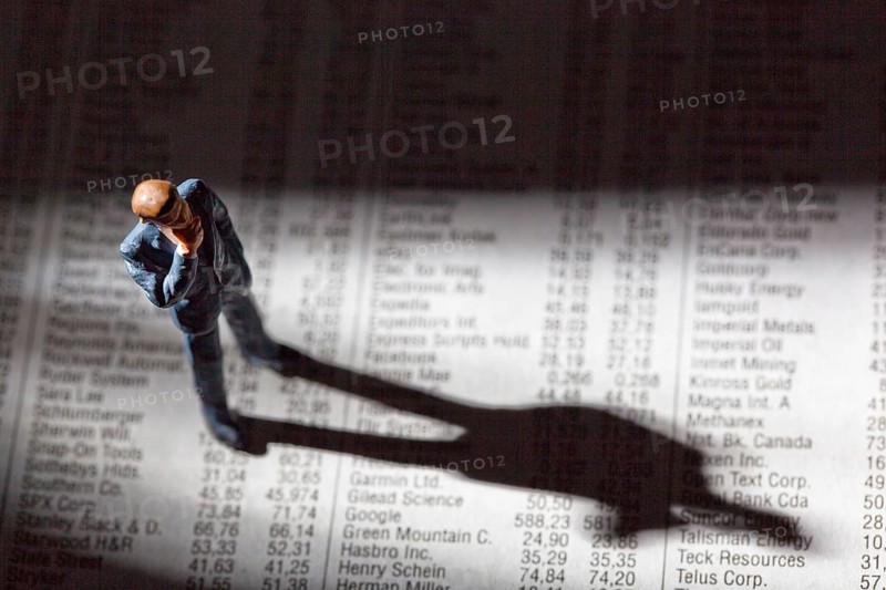 A small figure and the prices of shares in a newspaper. Earning money on the stock market. Profits and losses in share trading. Austria