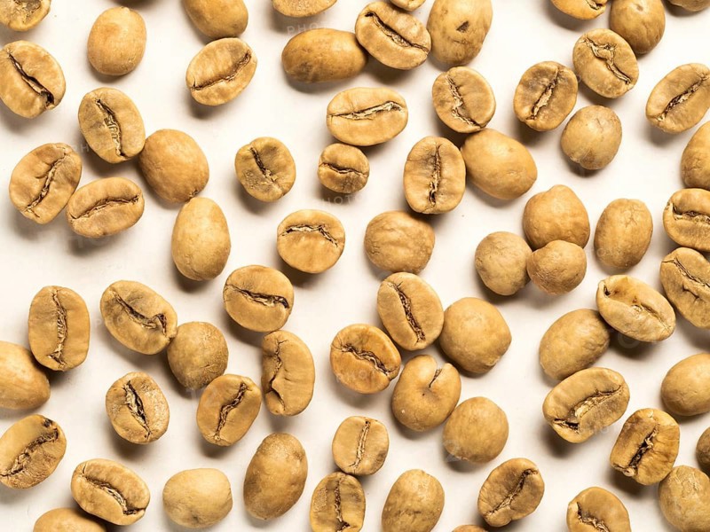 Top view of white coffee beans on white background