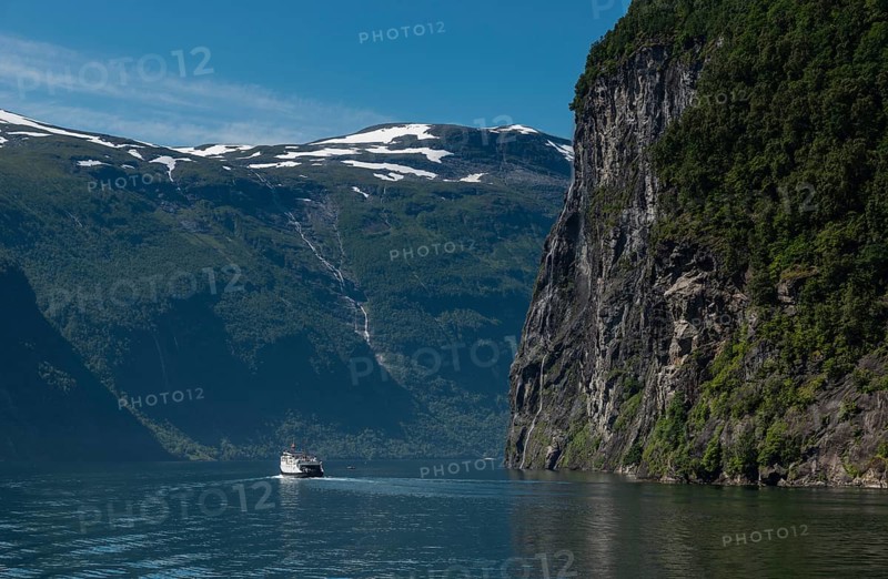 People on cruise boat at the famous geiranger fjord waterfalls in norway