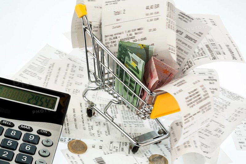 Shopping trolleys, banknotes and receipts, symbolising purchasing power, consumption and inflation Austria