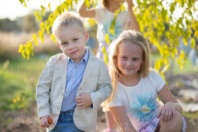 Little boy in a suit on the background of his sister