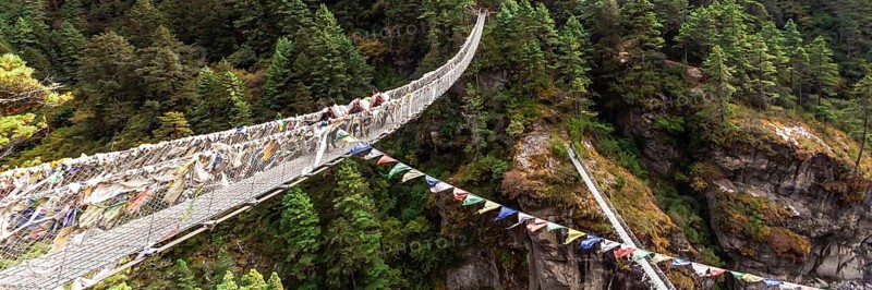 Suspention bridge on the Everest Base Camp Trek, Himalaya mountains, Sagarmatha National Park, Nepal. Web banner in panoramic view