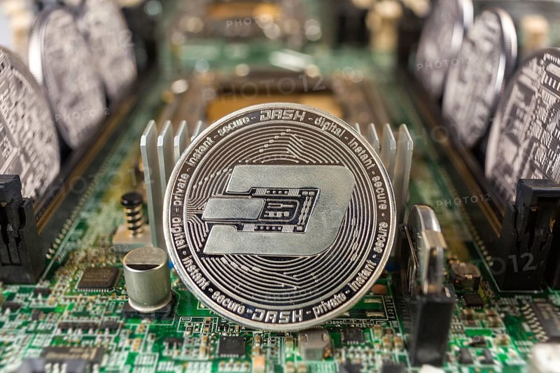 Dash coin close-up on a computer circuit motherboard as a blockchain technology payment network. Digital cryptocurrency concept and mining