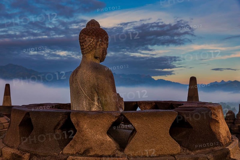 Buddha statue at sunrise, Borobudur temple complex, Borobudur, Yogyakarta, Java, Indonesia, Asia