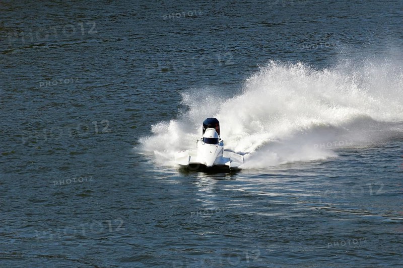 White Speedboat Making Turn with Splashes of Water during Race on Championship