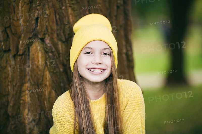 Cute teenage girl with braces smiling happily dressed in bright yellow clothes outdoors. Cute and happy teenage girl with braces smiling at camera. Alignment bite of teeth, correct bite of teeth