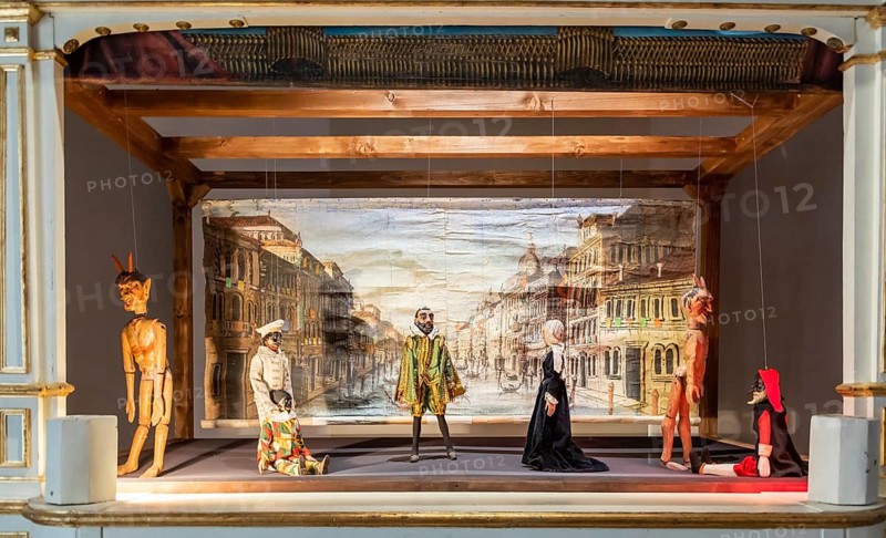 Vintage puppet show theatre made of wood. Old historical puppets