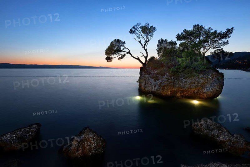 Sunset at beach with Kamen Brela (Brela Stone), Brela, Adriatic Sea, Croatia, Europe