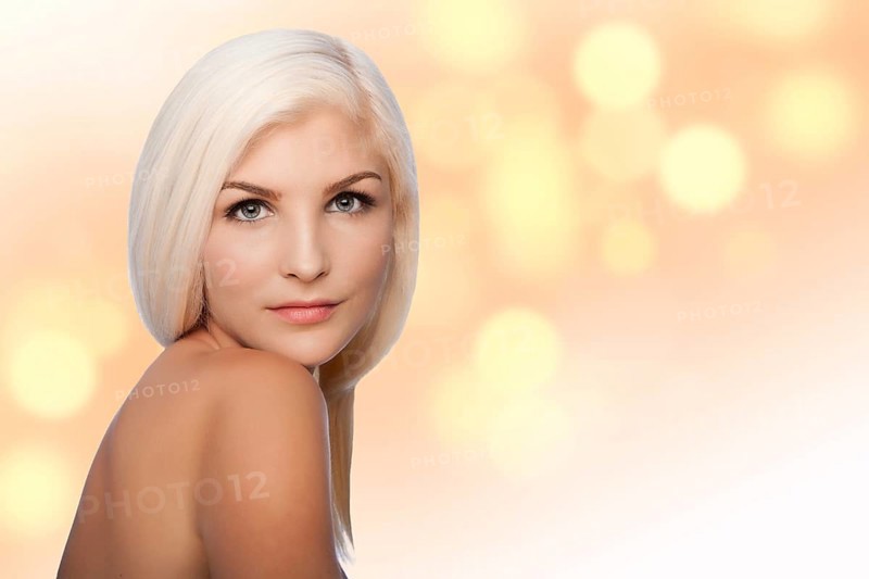 Beautiful face of young woman for Aesthetics facial skincare concept looking over shoulder, on blurred lights background, Atlanta, USA, North America