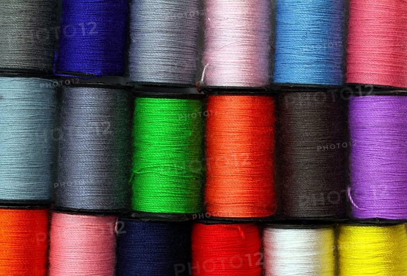 Lot of colored thread spools, background