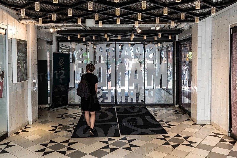 Uppsala, Uppland Sweden, 07 27 2019 Beautiful thirty year old woman in black dress walkig out of the Svava Matgalleria shopping mall