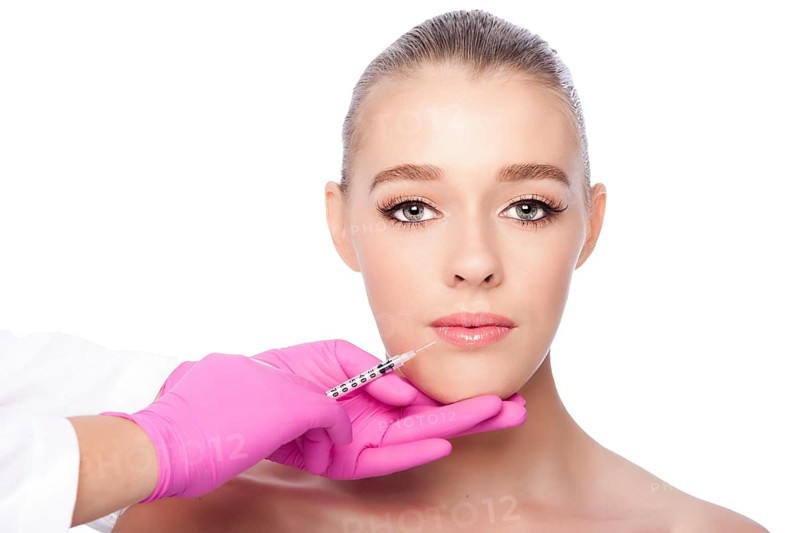 Beautiful face lip filler collagen injection Cosmetic spa beauty treatment with pink gloves, on white, Atlanta, USA, North America